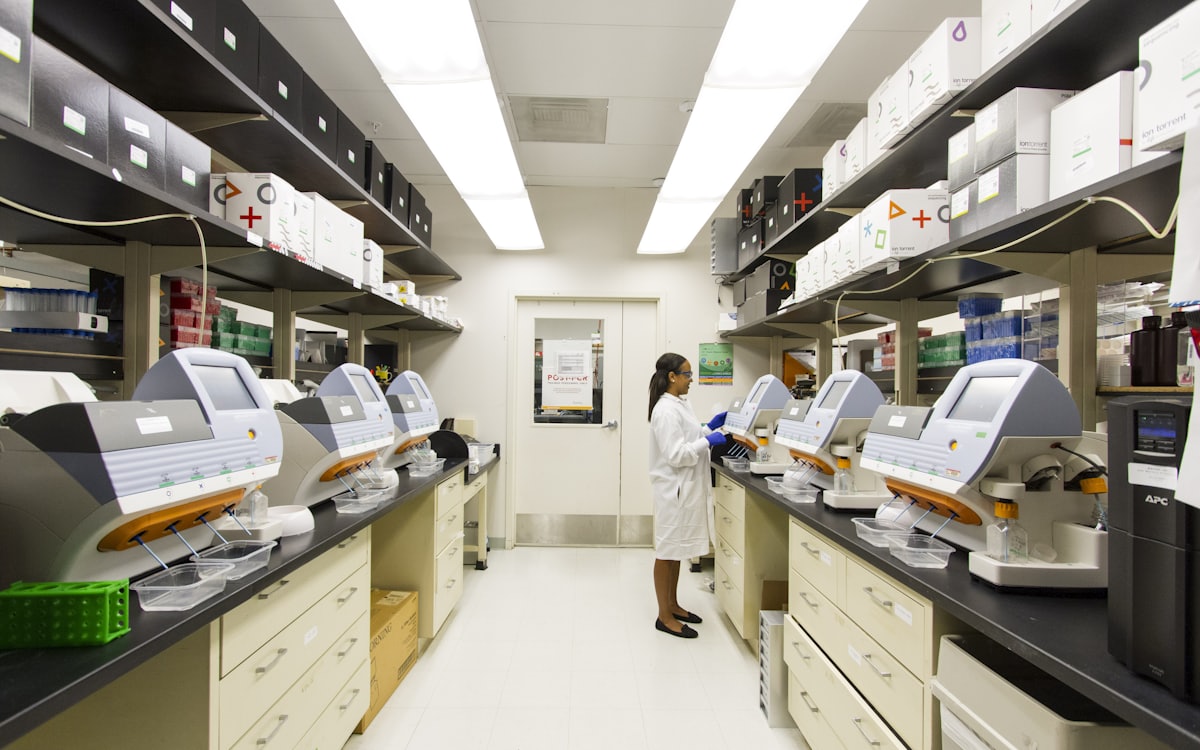 Laboratory technician running samples on analysers