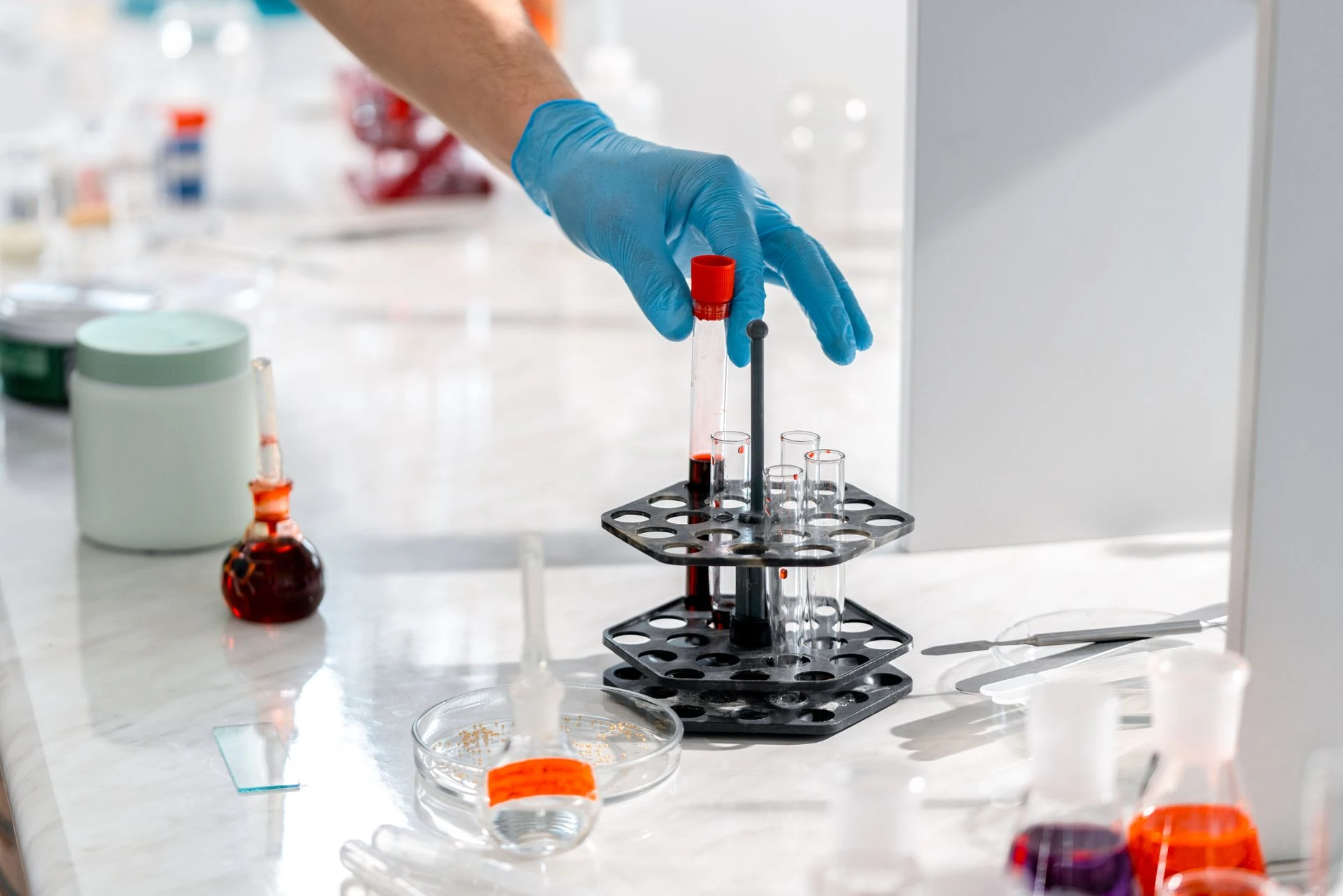 Technician preparing test tubes with a micropipette