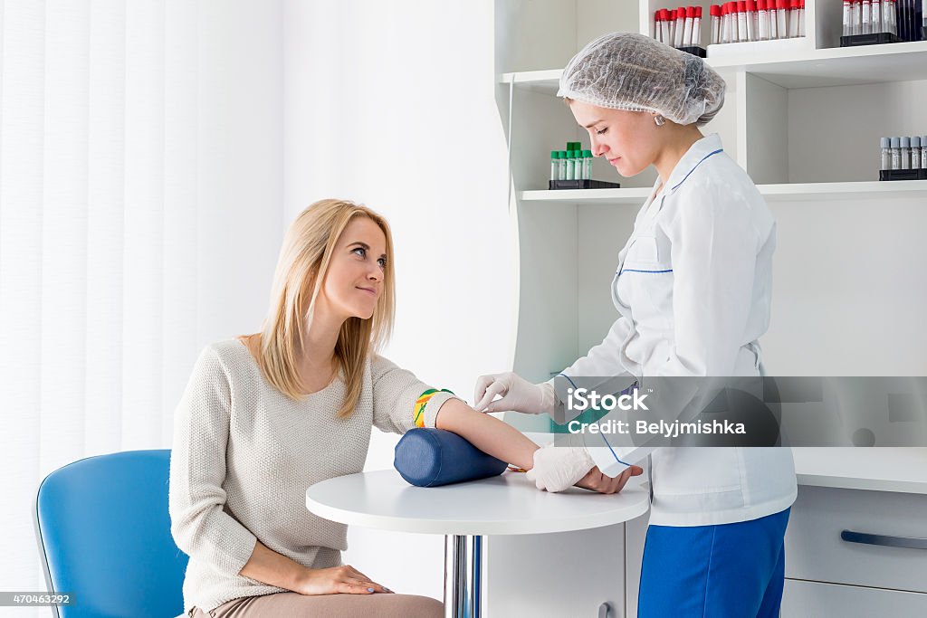 Phlebotomist preparing a patient for a blood draw